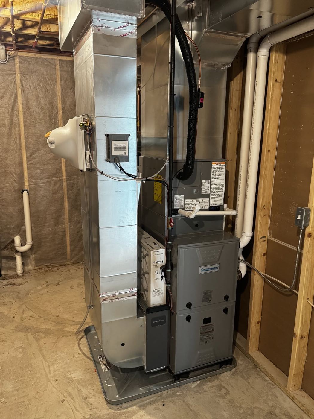 High-efficiency Comfortmaker furnace installed by Rockit HVAC in a West Michigan basement